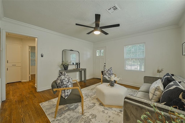 6109 NW 55th St, Oklahoma City, OK 73122 - living room with ceiling fan, wood finished floors, crown molding, and a textured ceiling