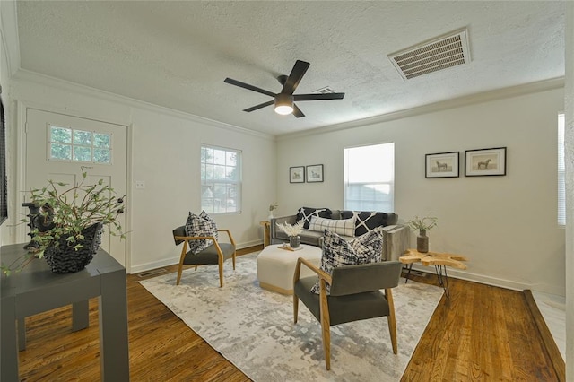 6109 NW 55th St, Oklahoma City, OK 73122 - living room with crown molding, a textured ceiling, dark wood finished floors, and ceiling fan