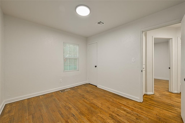 6109 NW 55th St, Oklahoma City, OK 73122 - spare room featuring wood finished floors and baseboards