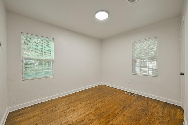 6109 NW 55th St, Oklahoma City, OK 73122 - unfurnished room with baseboards and wood finished floors