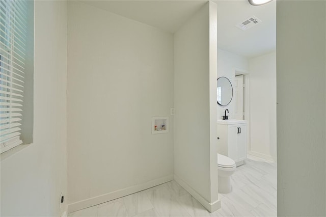 6109 NW 55th St, Oklahoma City, OK 73122 - washroom with light marble finish flooring and hookup for a washing machine