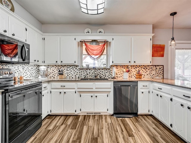 617 Hoehner Ave, Okarche, OK 73762 - kitchen with range with electric stovetop, stainless steel dishwasher, white cabinetry, tasteful backsplash, and light stone counters