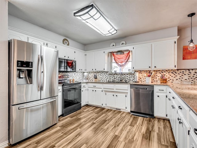 617 Hoehner Ave, Okarche, OK 73762 - kitchen with stainless steel appliances, light wood-style flooring, white cabinetry, and decorative backsplash