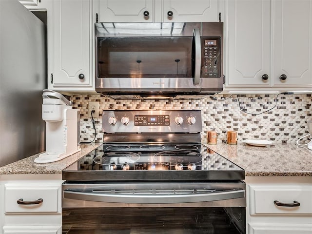 617 Hoehner Ave, Okarche, OK 73762 - kitchen featuring appliances with stainless steel finishes, white cabinets, tasteful backsplash, and light stone counters