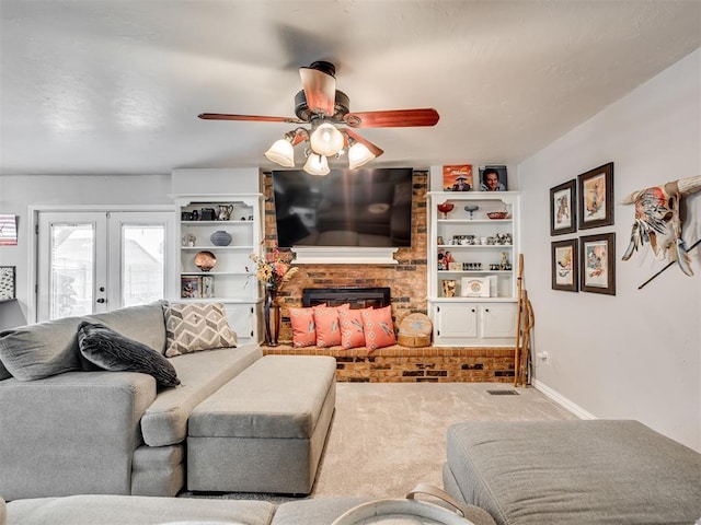 617 Hoehner Ave, Okarche, OK 73762 - living area with carpet flooring, ceiling fan, french doors, and a fireplace