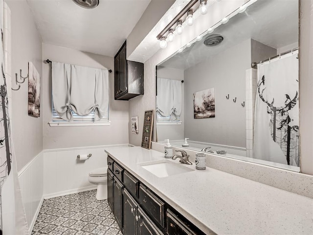 617 Hoehner Ave, Okarche, OK 73762 - bathroom with vanity, a wainscoted wall, and a shower with shower curtain