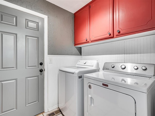 617 Hoehner Ave, Okarche, OK 73762 - laundry room featuring washer and dryer, cabinet space, and wainscoting