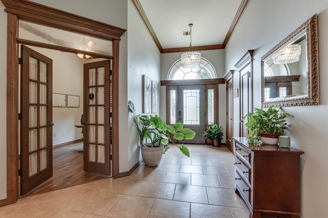 825 Silver Tree Dr, Choctaw, OK 73020 - foyer entrance featuring crown molding, french doors, a chandelier, and light tile patterned floors