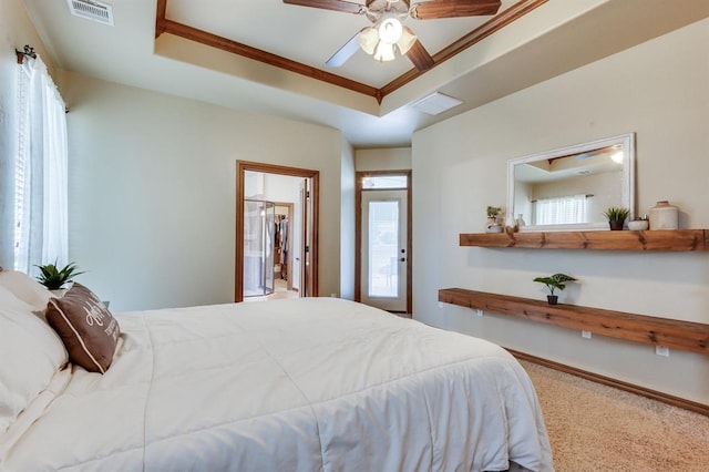 825 Silver Tree Dr, Choctaw, OK 73020 - bedroom featuring a tray ceiling, multiple windows, carpet floors, and ceiling fan