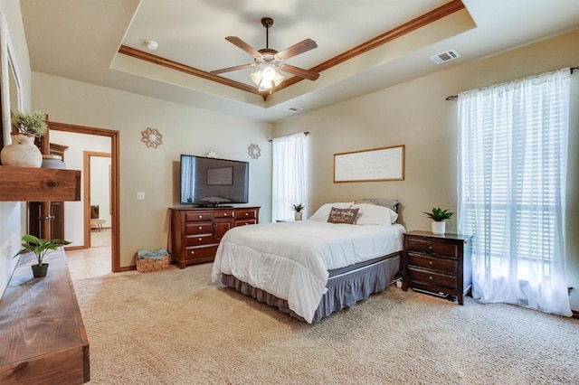 825 Silver Tree Dr, Choctaw, OK 73020 - bedroom featuring a tray ceiling, light colored carpet, ornamental molding, and a ceiling fan