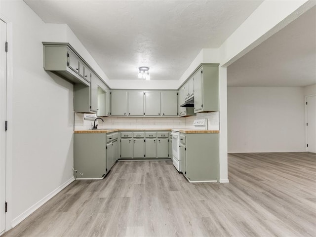 2550 Clarke St, Choctaw, OK 73020 - kitchen featuring light wood-type flooring, white electric range, tasteful backsplash, and light countertops