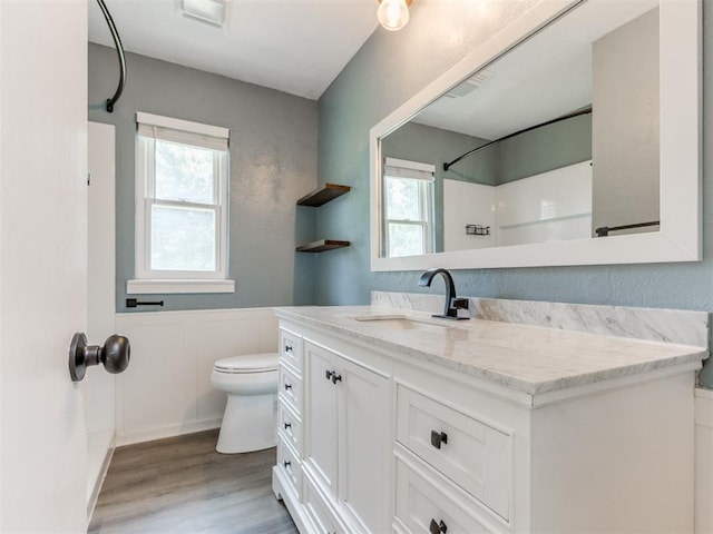 2550 Clarke St, Choctaw, OK 73020 - bathroom with a shower, plenty of natural light, vanity, wood finished floors, and a wainscoted wall