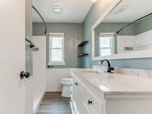 2550 Clarke St, Choctaw, OK 73020 - full bath featuring a shower, vanity, plenty of natural light, and wood finished floors