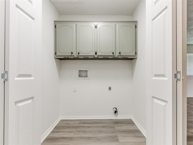2550 Clarke St, Choctaw, OK 73020 - washroom with hookup for an electric dryer, washer hookup, cabinet space, and light wood-style flooring