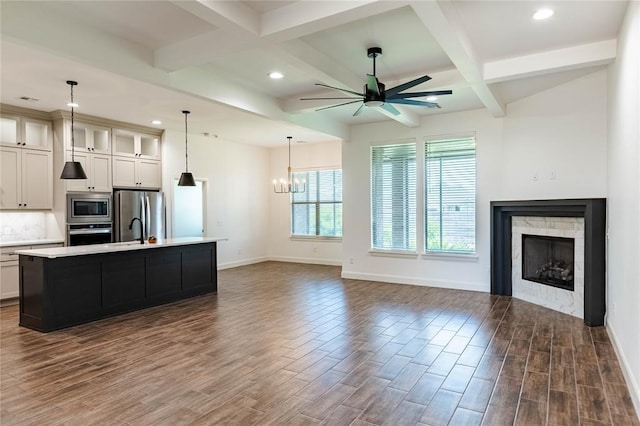 14704 Ashore Dr, Oklahoma City, OK 73142 - kitchen with appliances with stainless steel finishes, ceiling fan, dark wood-style flooring, light countertops, and coffered ceiling