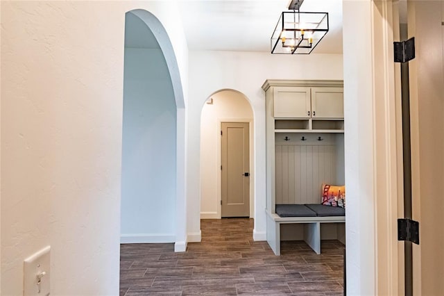 14704 Ashore Dr, Oklahoma City, OK 73142 - mudroom featuring dark wood-style floors, arched walkways, and a chandelier