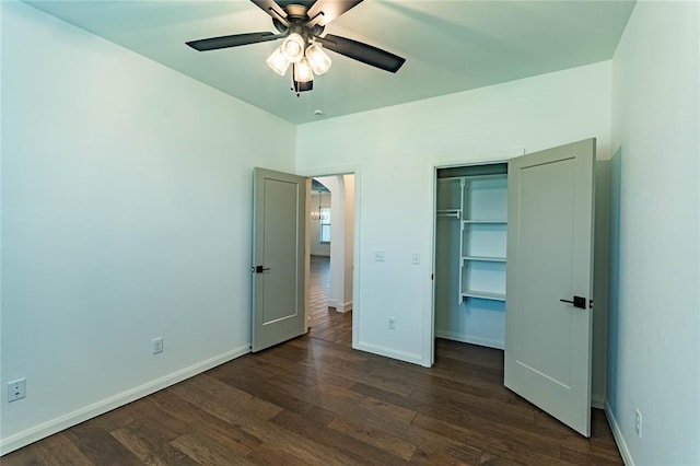 14704 Ashore Dr, Oklahoma City, OK 73142 - unfurnished bedroom with dark wood-type flooring, a ceiling fan, and a walk in closet