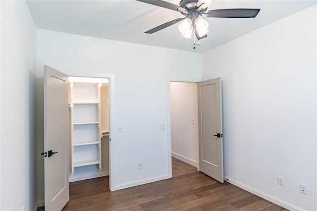 14704 Ashore Dr, Oklahoma City, OK 73142 - unfurnished bedroom with wood finished floors, a walk in closet, and ceiling fan