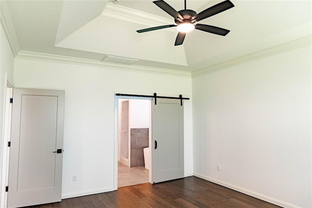 14704 Ashore Dr, Oklahoma City, OK 73142 - unfurnished bedroom with ornamental molding, dark wood-type flooring, a barn door, ensuite bath, and ceiling fan
