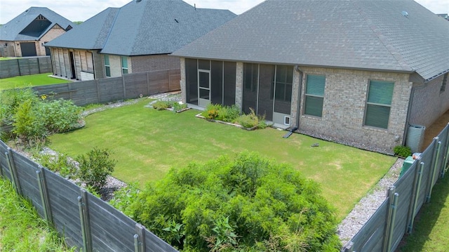 14704 Ashore Dr, Oklahoma City, OK 73142 - back of property with a shingled roof, a sunroom, brick siding, and a fenced backyard