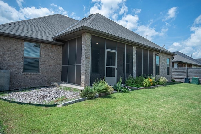 14704 Ashore Dr, Oklahoma City, OK 73142 - rear view of house featuring a sunroom, roof with shingles, and brick siding