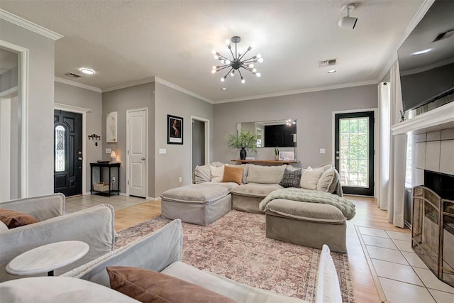 4155 NW Terrace Hills Rd, Piedmont, OK 73078 - living area with a chandelier, light tile patterned floors, a tiled fireplace, ornamental molding, and recessed lighting