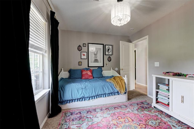4155 NW Terrace Hills Rd, Piedmont, OK 73078 - carpeted bedroom featuring a chandelier and baseboards