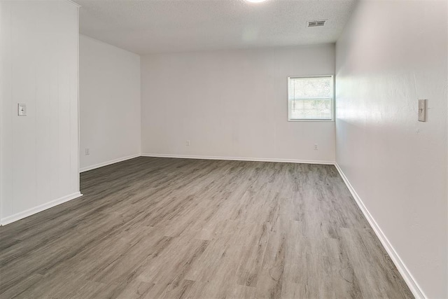 6609 SE 15th St, Oklahoma City, OK 73110 - empty room featuring wood finished floors and a textured ceiling