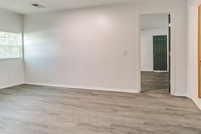 6609 SE 15th St, Oklahoma City, OK 73110 - unfurnished room featuring wood finished floors and a textured ceiling