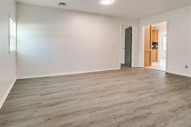 6609 SE 15th St, Oklahoma City, OK 73110 - unfurnished room featuring wood finished floors and a textured ceiling
