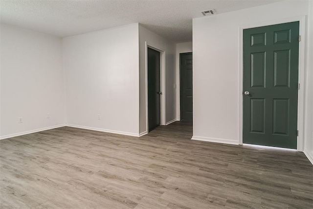 6609 SE 15th St, Oklahoma City, OK 73110 - unfurnished room with wood finished floors and a textured ceiling