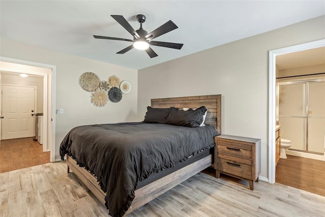 12281 SW 11th St, Yukon, OK 73099 - bedroom with light wood-type flooring, ensuite bath, and a ceiling fan