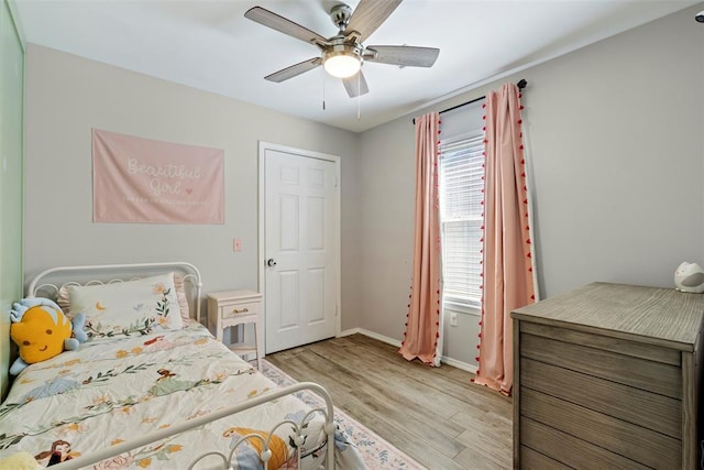 12281 SW 11th St, Yukon, OK 73099 - bedroom with light wood finished floors and ceiling fan