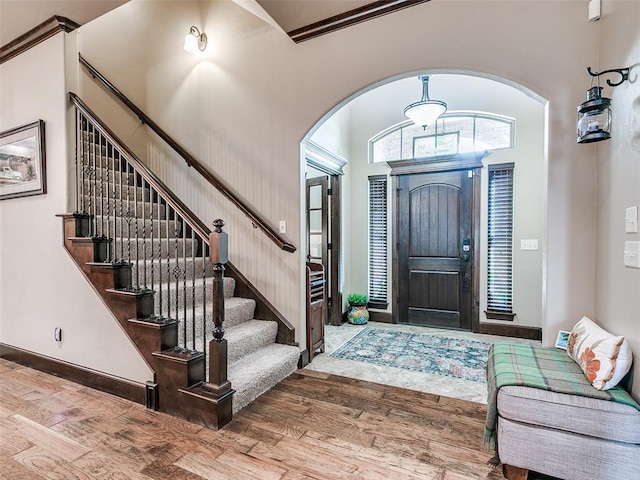 17401 Melville Ln, Edmond, OK 73012 - entryway with arched walkways, wood finished floors, and stairs
