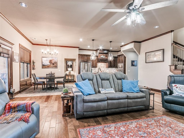 17401 Melville Ln, Edmond, OK 73012 - living room featuring wood-type flooring, crown molding, a chandelier, recessed lighting, and a ceiling fan