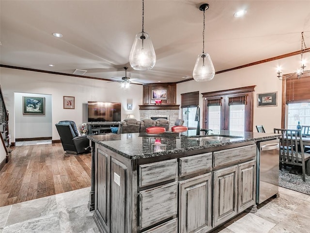 17401 Melville Ln, Edmond, OK 73012 - kitchen featuring a fireplace, stainless steel dishwasher, ornamental molding, ceiling fan, and recessed lighting