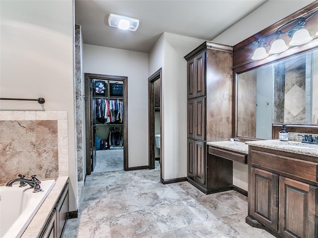 17401 Melville Ln, Edmond, OK 73012 - bathroom featuring a bath, vanity, and a spacious closet
