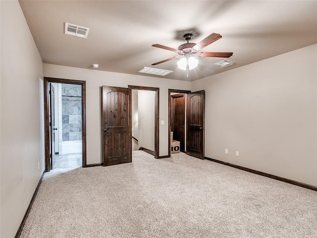 17401 Melville Ln, Edmond, OK 73012 - unfurnished bedroom with carpet, ensuite bath, and a ceiling fan