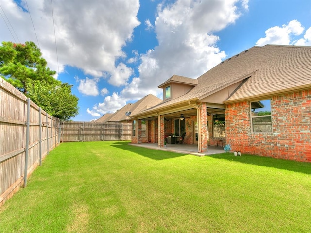 17401 Melville Ln, Edmond, OK 73012 - fenced backyard with a ceiling fan and a patio