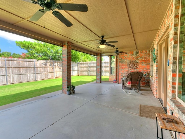 17401 Melville Ln, Edmond, OK 73012 - fenced backyard with a ceiling fan and a patio