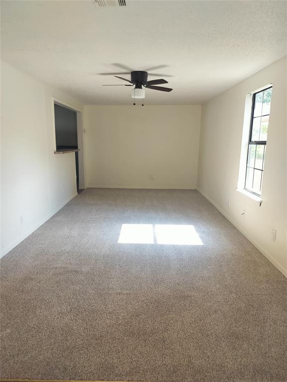 116 SE 39th St, Oklahoma City, OK 73129 - empty room featuring light carpet and a ceiling fan