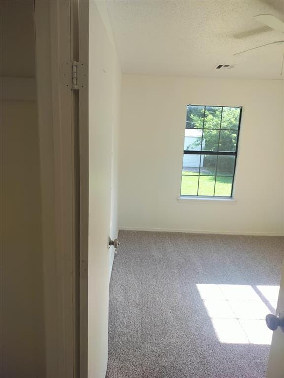 116 SE 39th St, Oklahoma City, OK 73129 - spare room featuring carpet flooring, ceiling fan, and a textured ceiling