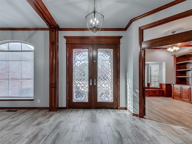 1217 Camelot Dr, Yukon, OK 73099 - entryway featuring french doors, light wood finished floors, a chandelier, crown molding, and ceiling fan