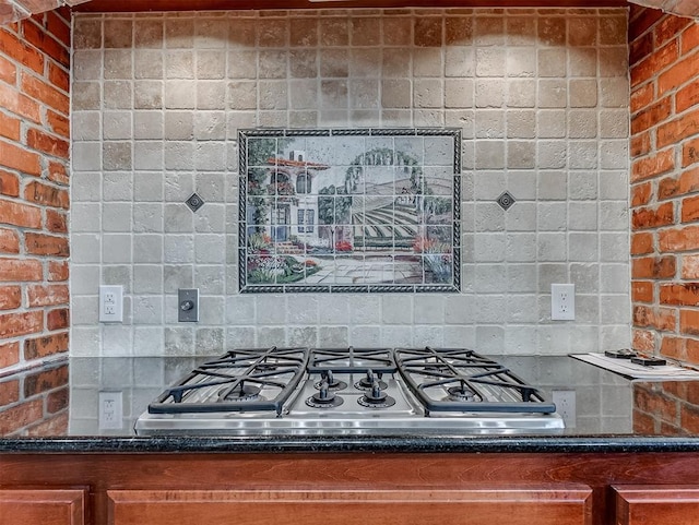 1217 Camelot Dr, Yukon, OK 73099 - kitchen featuring stainless steel gas cooktop, dark stone counters, and brown cabinetry