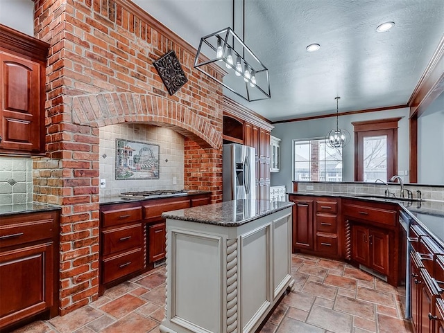 1217 Camelot Dr, Yukon, OK 73099 - kitchen featuring a chandelier, light stone finish floors, appliances with stainless steel finishes, a textured ceiling, and pendant lighting