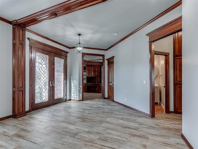 1217 Camelot Dr, Yukon, OK 73099 - entryway featuring ornamental molding, french doors, light wood-style floors, and a chandelier