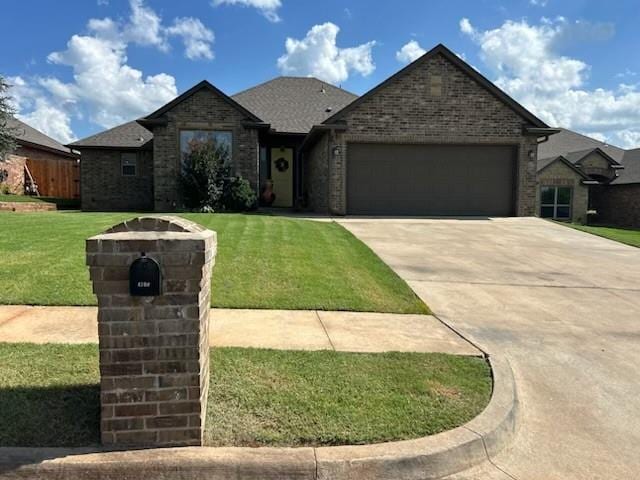 4700 Grand Ave, Noble, OK 73068 - ranch-style home with brick siding, an attached garage, a front lawn, and concrete driveway