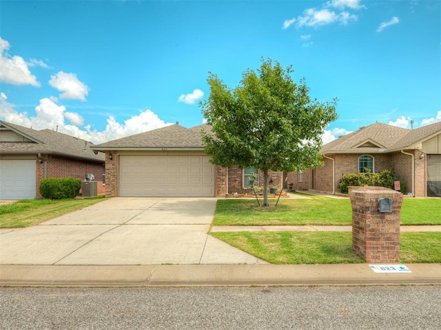 623 SW 37th St, Moore, OK 73160 - view of front of property with a front lawn, a garage, concrete driveway, and brick siding