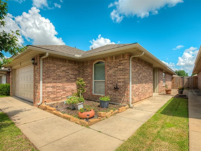 623 SW 37th St, Moore, OK 73160 - view of side of property with an attached garage, brick siding, concrete driveway, and roof with shingles