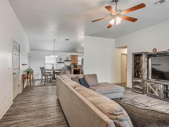 623 SW 37th St, Moore, OK 73160 - living area with dark wood-style floors, a ceiling fan, vaulted ceiling, and a chandelier